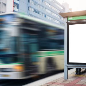 A bus driving past a bus stop