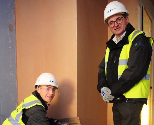 Plastering student working under supervision