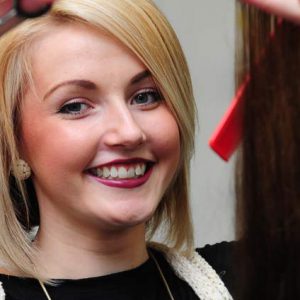 Hairdresser Katie holds up hair extensions