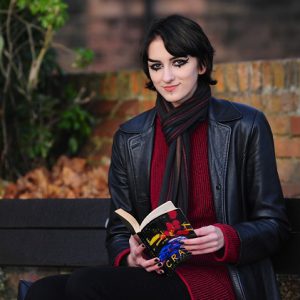 Monika Burtniece sat on a bench reading a book